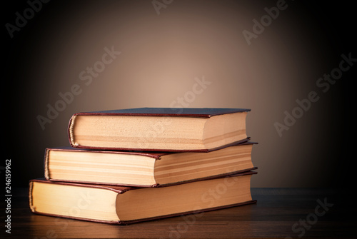 books on a blurred brown background and a bright circle