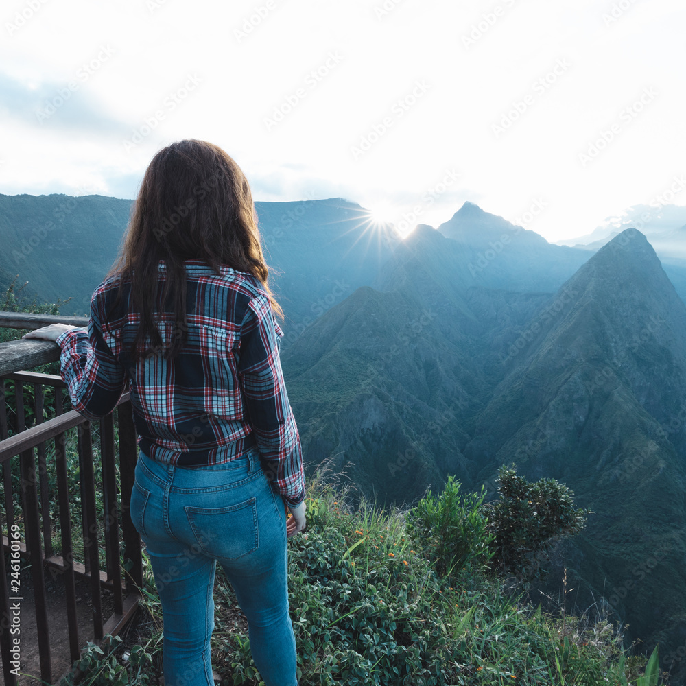 Girl watching the sunrise at Cap Noir, Reunion Island