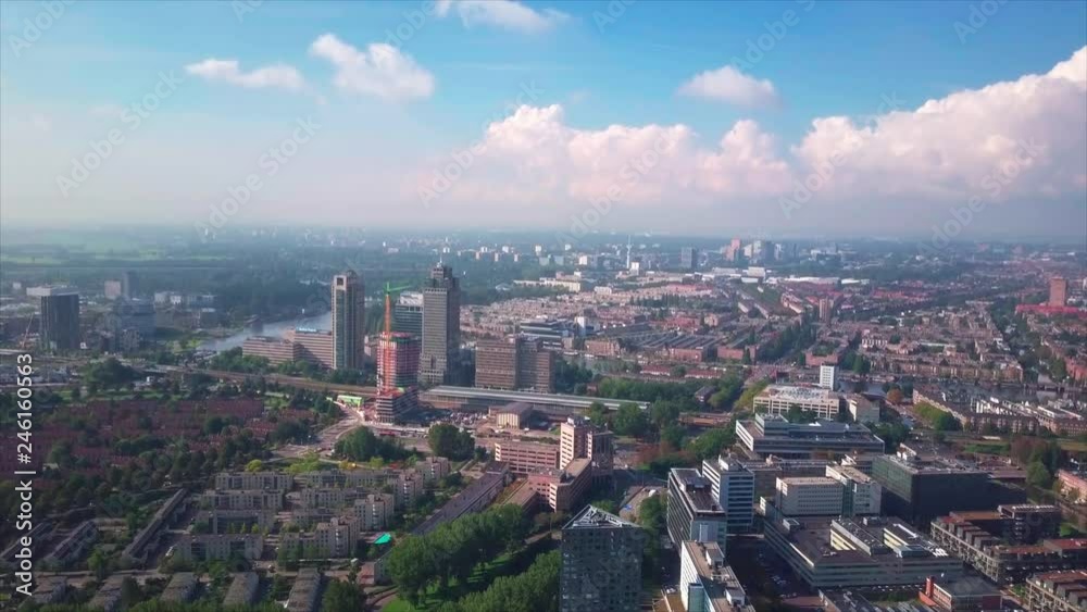 Aerial view of the city of Amsterdam - flying drone on the Dutch capital revealing its beautiful neighborhoods, parks and canals. Northern Europe, Holland. Aerial view of the city of Amsterdam - flying drone on the Dutch capital revealing its beautiful neighborhoods, parks and canals. Northern Europe, Holland.