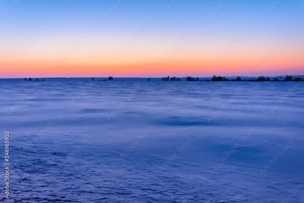 Sunrise in winter in the field