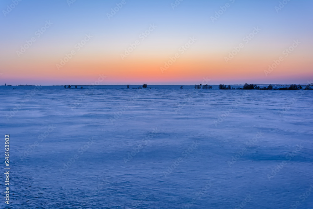 Sunrise in winter in the field