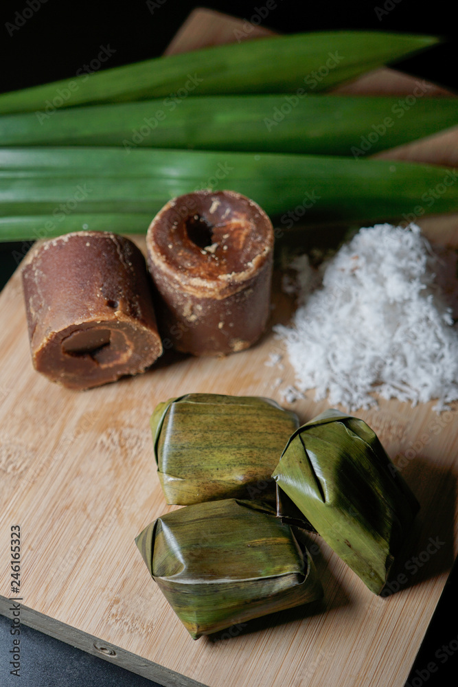 Koci the malay glutinous rice ball served in banana leaf . Malaysian