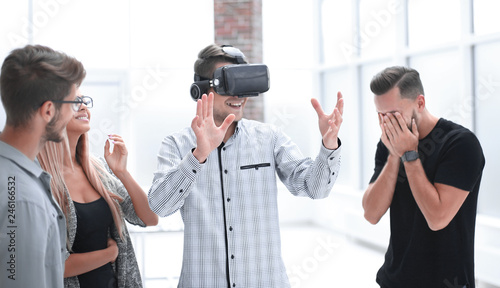 Young doctor watching male in VR goggles