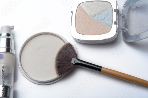 Beige face powder and makeup brushes isolated on white background. photo