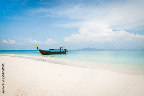 Sea landscape. A longtale boat on a white beach at Krabi, Thailand. 