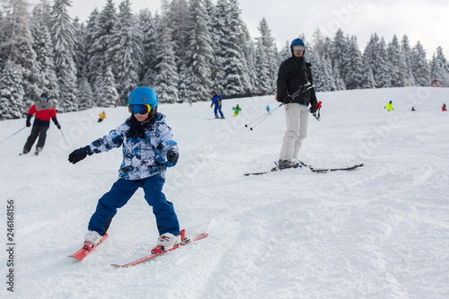 Father and child, skiing together in Austrian resort