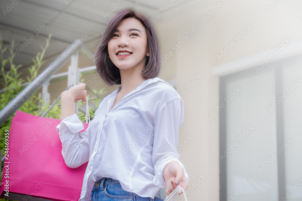 happy woman smile and holding shpping bags shopping on the day happy woman smile and holding shpping bags shopping on the day