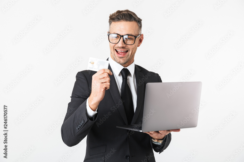 Handsome business man isolated over white wall background using laptop computer. Handsome business man isolated over white wall background using laptop computer.