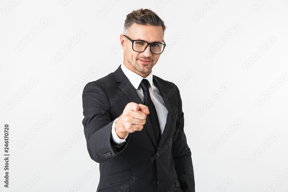 Handsome business man isolated over white wall background posing pointing. Handsome business man isolated over white wall background posing pointing.