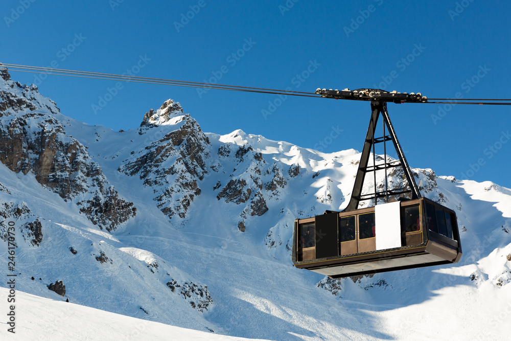 Cable car on the ski resort in France. Beautiful winter landscape and snow covered mountains Cable car on the ski resort in France. Beautiful winter landscape and snow covered mountains