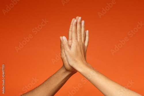 Man and woman greeting each other with high five