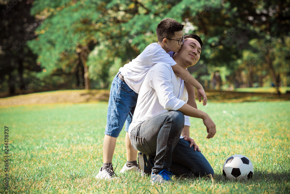 Happy children and parents playing in the park. Concept family relaxation. Happy children and parents playing in the park. Concept family relaxation.