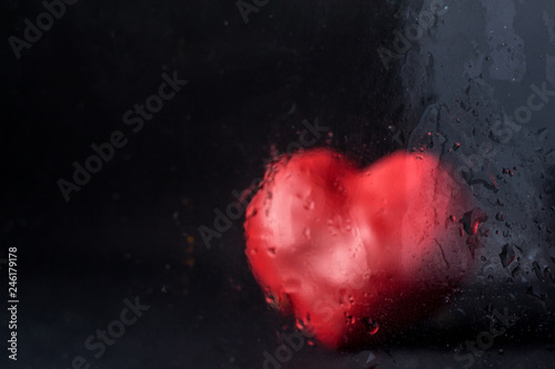Fototapeta Naklejka Na Ścianę i Meble -  Drops on glass against red heart