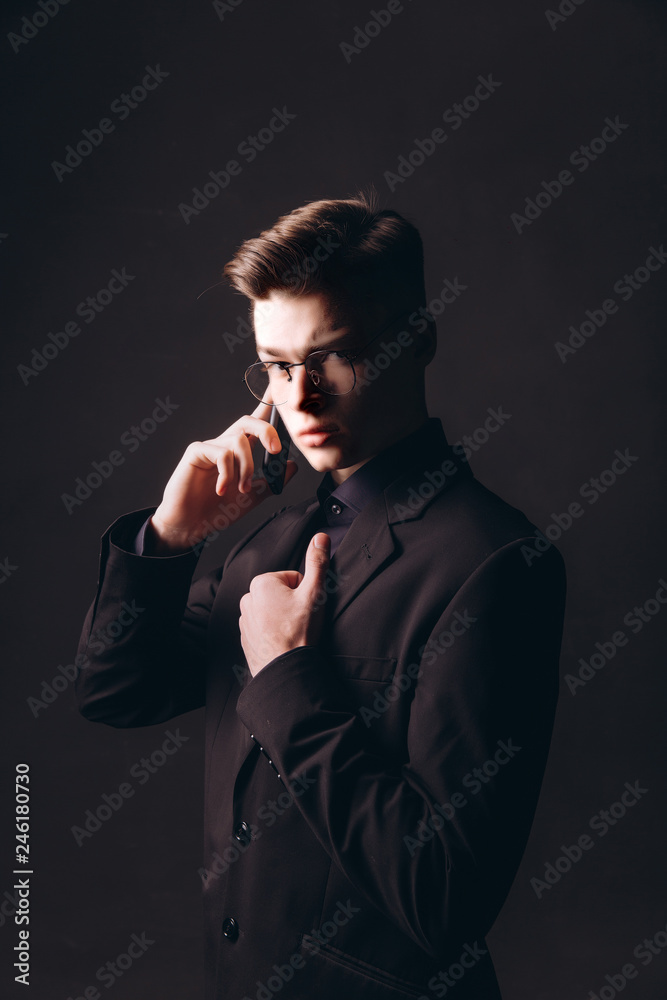 Handsome businessman speaking on mobile phone in office - Image