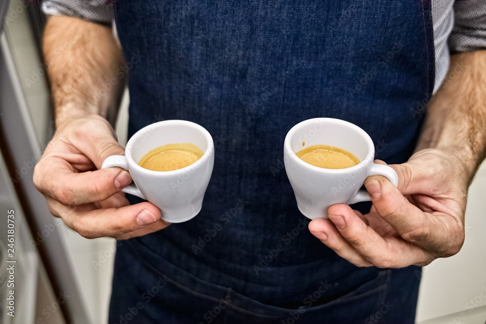 Barista with two cups of hot coffee Barista with two cups of hot coffee