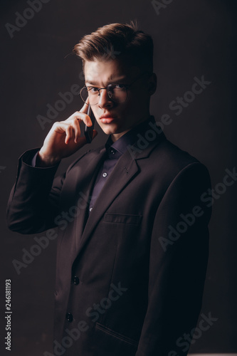 Portrait of a businessman talking on the phone - Image. Portrait of successful young man calling on cellular phone outside - Image © ZoomStudio