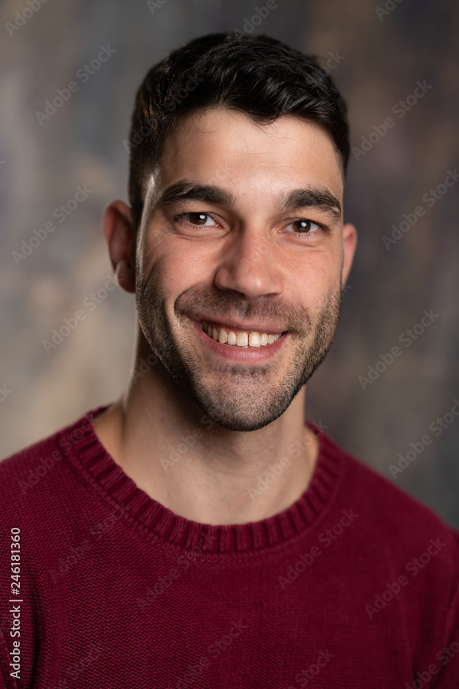 Handsome caucasian white male with black short hair and stubble and burgundy sweater jersey Handsome caucasian white male with black short hair and stubble and burgundy sweater jersey