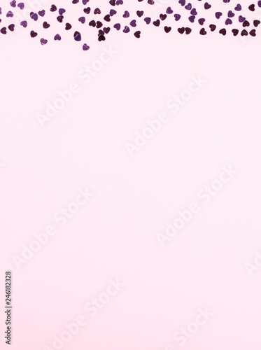 Flat lay top view  glitter confettiin the shape of a heart on pink background. .Greeting card Festive holiday pastel backdrop Love. Birthday congratulations St. Valentine's Day .Copy space for Text © lily_rocha