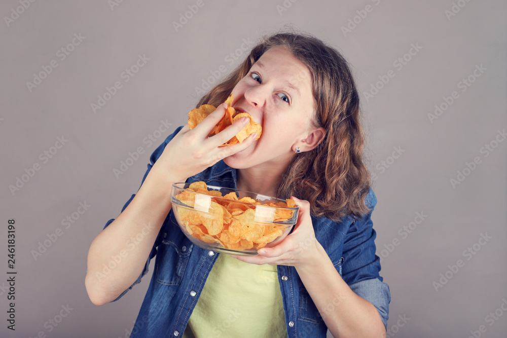 Portrait of girl with a glass bowl full of chips. Portrait of girl with a glass bowl full of chips.