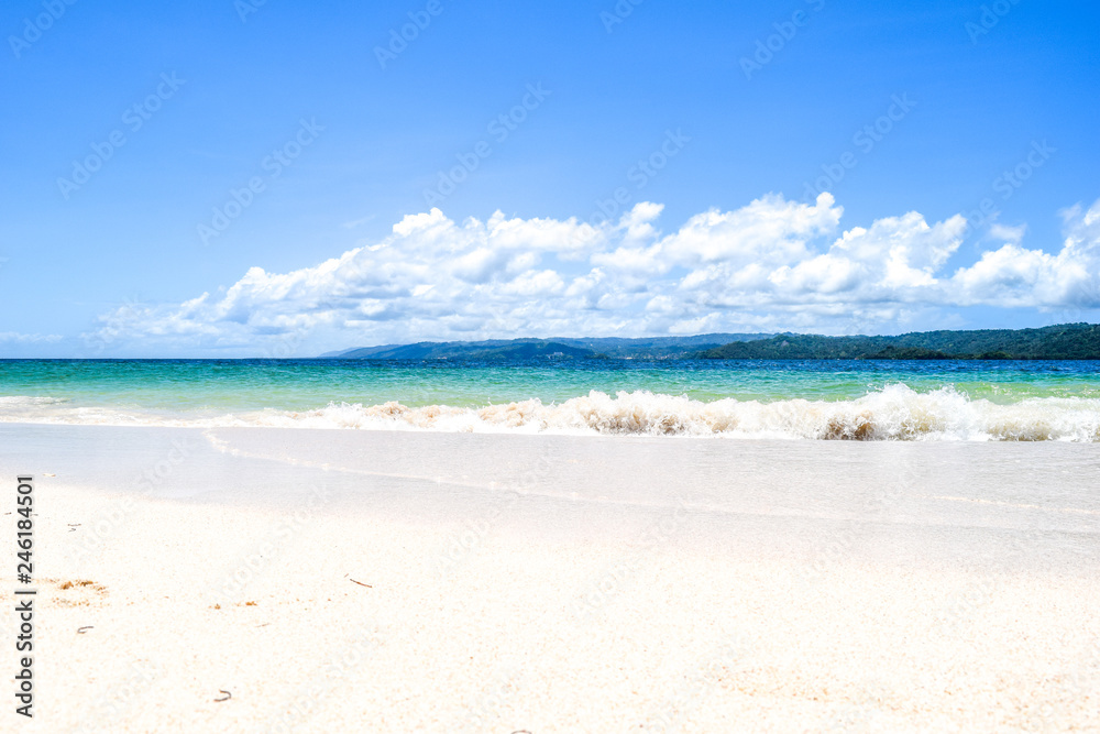 Caribbean island white beach with blue turquoise ocean and waves, blue sky with some clouds, paradise island at cayo levantado Caribbean island white beach with blue turquoise ocean and waves, blue sky with some clouds, paradise island at cayo levantado