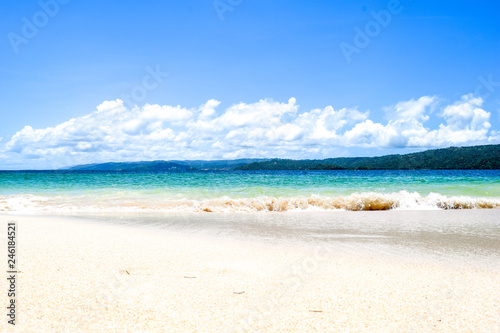 Fototapeta Naklejka Na Ścianę i Meble -  island with white beach blue turquoise ocean and waves, blue sky with some clouds, paradise island at cayo levantado