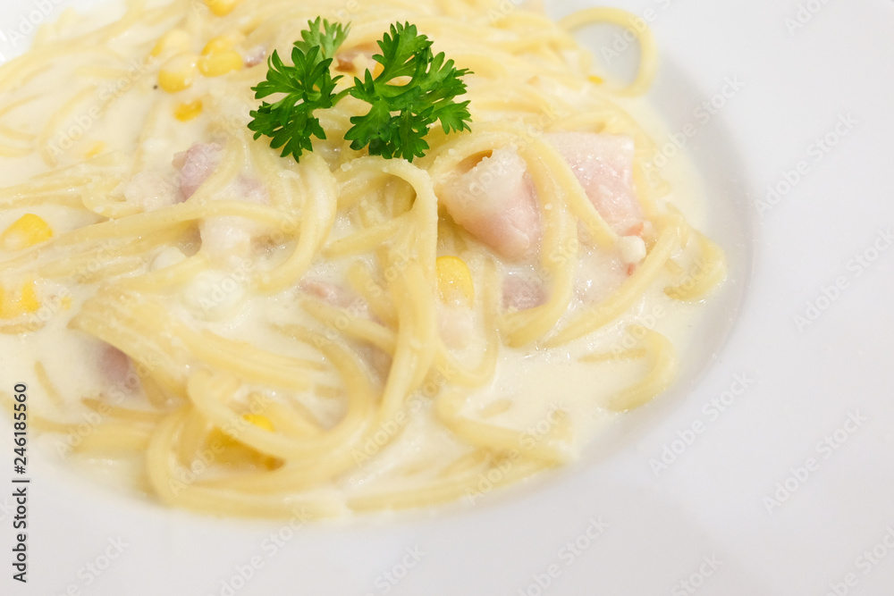 The spaghetti bacon, corn and cream cheese with on white dish set on table for food background or texture - homemade food concept. The spaghetti bacon, corn and cream cheese with on white dish set on table for food background or texture - homemade food concept.
