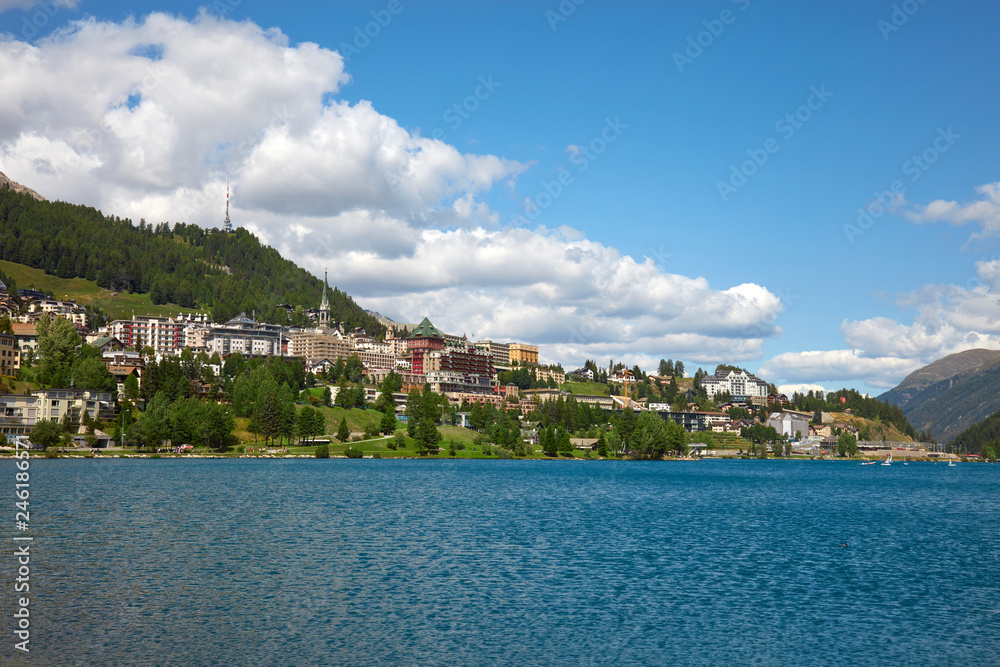 Sankt Moritz town and lake in a sunny summer day, white clouds in Switzerland