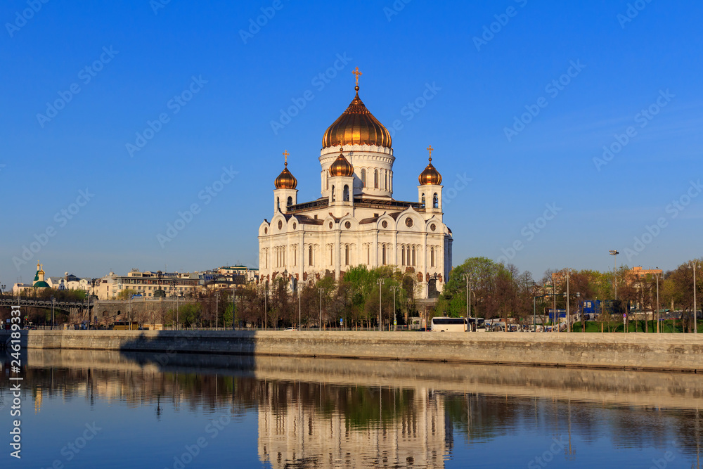 Cathedral of Christ the Saviour in Moscow on a background of Prechistenskaya Embankment of Moskva river at sunny spring morning