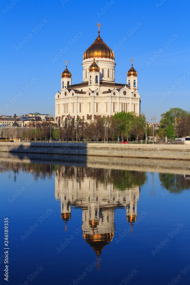 Cathedral of Christ the Saviour with reflection on water surface of Moskva river at sunny spring morning