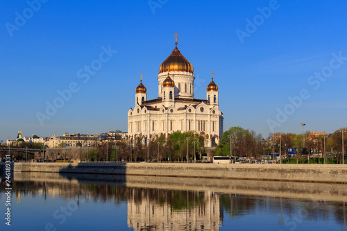 Cathedral of Christ the Saviour in Moscow on a background of Prechistenskaya Embankment of Moskva river at sunny spring morning
