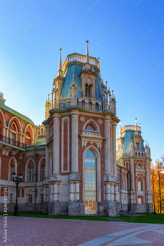 Fototapeta premium Fragment of Grand palace in Tsaritsyno park in Moscow against blue sky at sunny autumn day