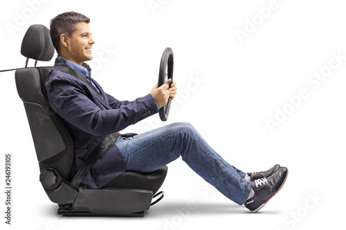 Obraz na plátně |Young man in a car seat with a fastened seat belt holding a streering wheel