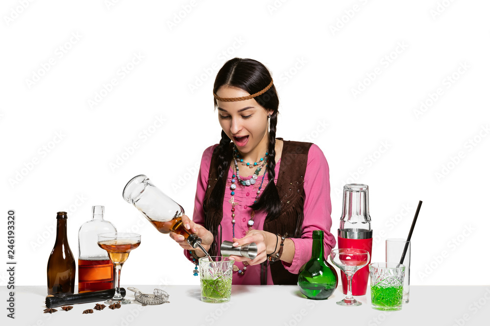 Expert female barman is making cocktail at studio isolated on white background. International barman day, bar, alcohol, restaurant, party, pub, nightlife, cocktail, nightclub concept Expert female barman is making cocktail at studio isolated on white background. International barman day, bar, alcohol, restaurant, party, pub, nightlife, cocktail, nightclub concept