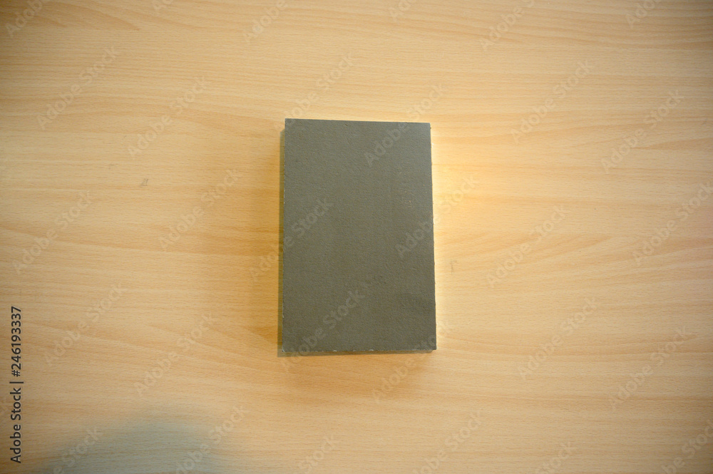 Grey book on the wood table Grey book on the wood table