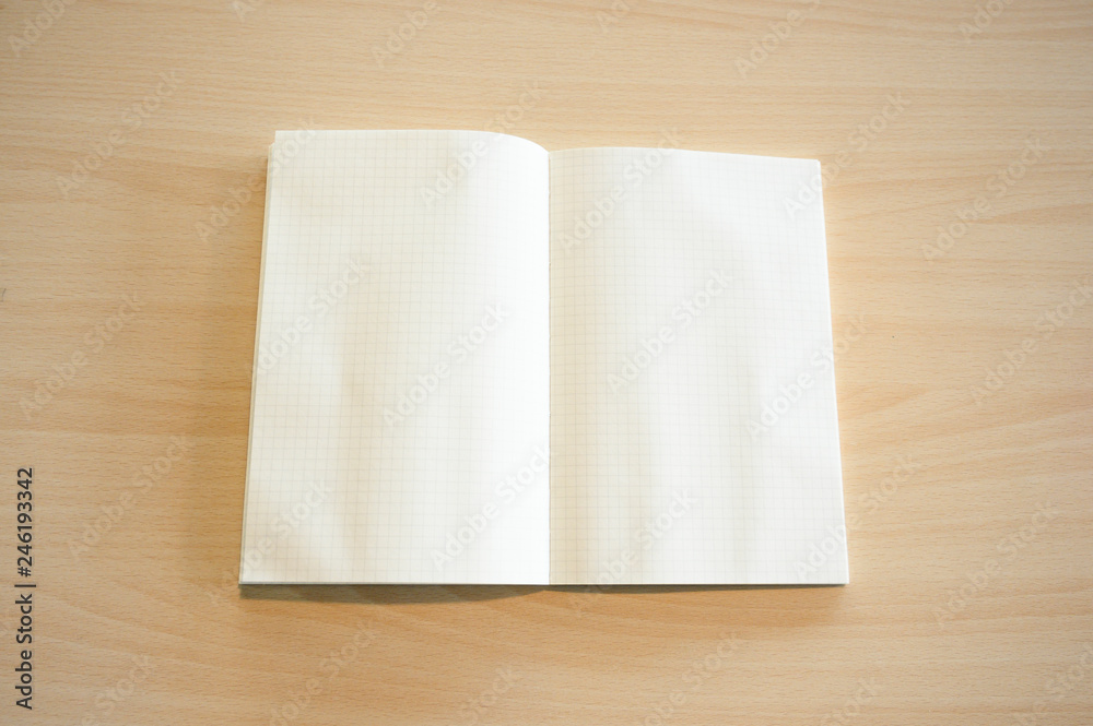 Grid book on the wood table Grid book on the wood table