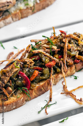 spicy dried squid and vegetables toast tapas snack in portugal photo