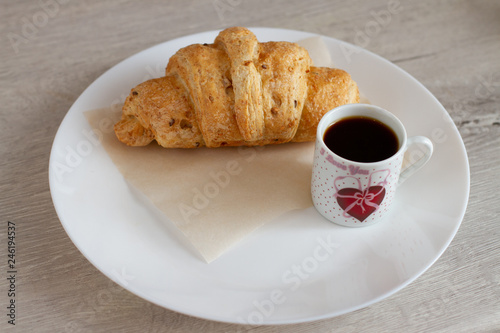 cup of coffee and cake on wooden table