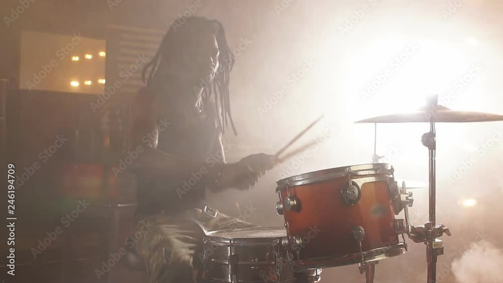 Talented drummer performing at night club.