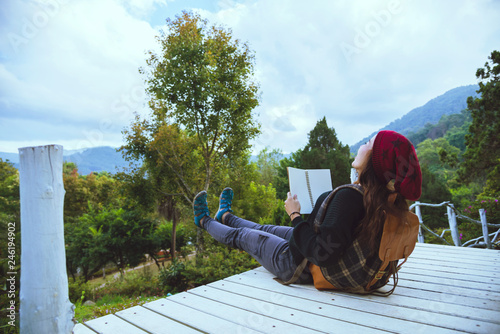 Asian women relax in the holiday. Study read a book. Read a book In the garden on the Moutain. In Thailand
