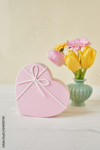 Fototapeta Naklejka Na Ścianę i Meble -  Valentine's day composition pink gift box with flowers. Valentine card. Greeting card template. Space for text. Concept of Happy Valentine's day. Mother's day card. Spring flowers on pink background