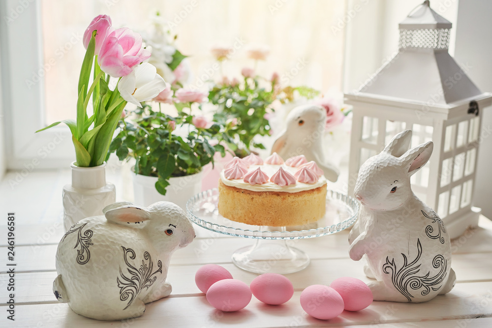 Easter composition with sweet bread, kulich and eggs with rabbits. Easter holidays breakfast concept with copy space. Easter Greeting Card Template. Easter eggs with cake on white wooden table Easter composition with sweet bread, kulich and eggs with rabbits. Easter holidays breakfast concept with copy space. Easter Greeting Card Template. Easter eggs with cake on white wooden table