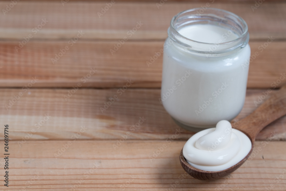 homemade yogurt in a spoon. wooden spoon with yogurt. homemade yogurt in a spoon. wooden spoon with yogurt.