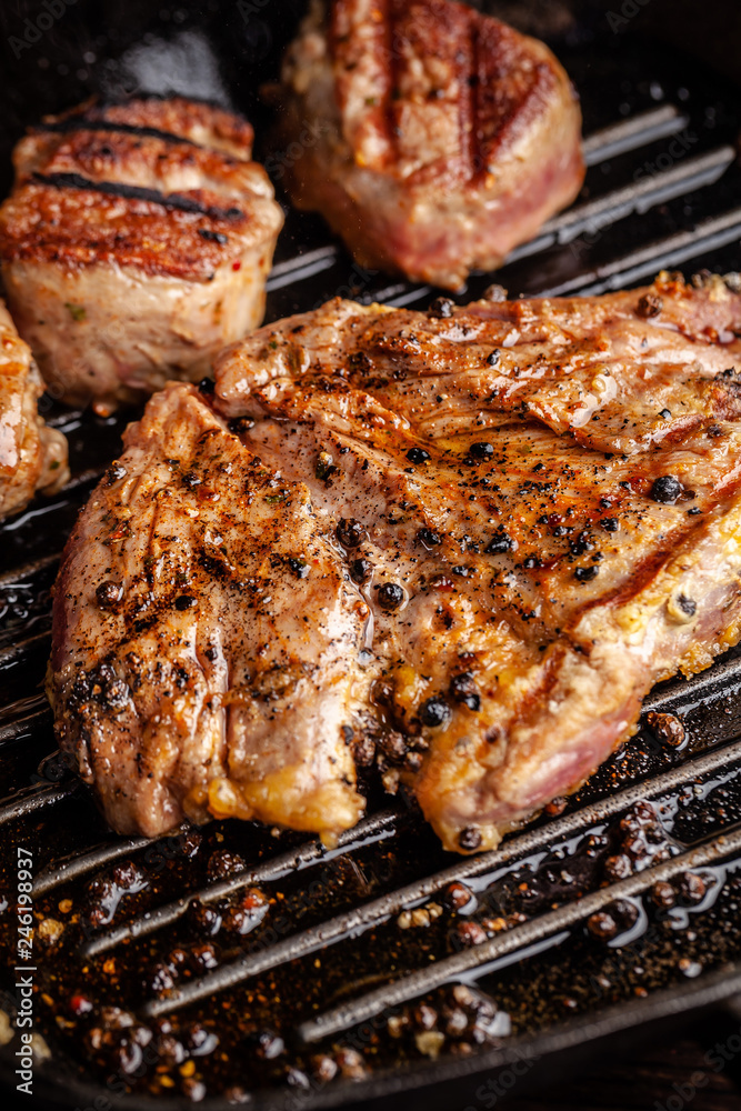 American cuisine concept. A juicy meat steak steak with black pepper is grilled on a cast-iron pan. Proper cooking of meat at home. Background image for a menu in restaurants or cafes. copy space