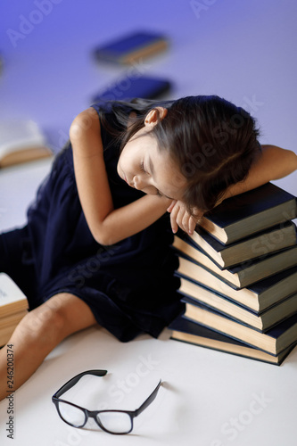 cute little girl is reading a book.