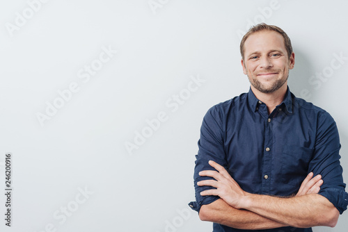 Happy successful young man with a pleased smile photo