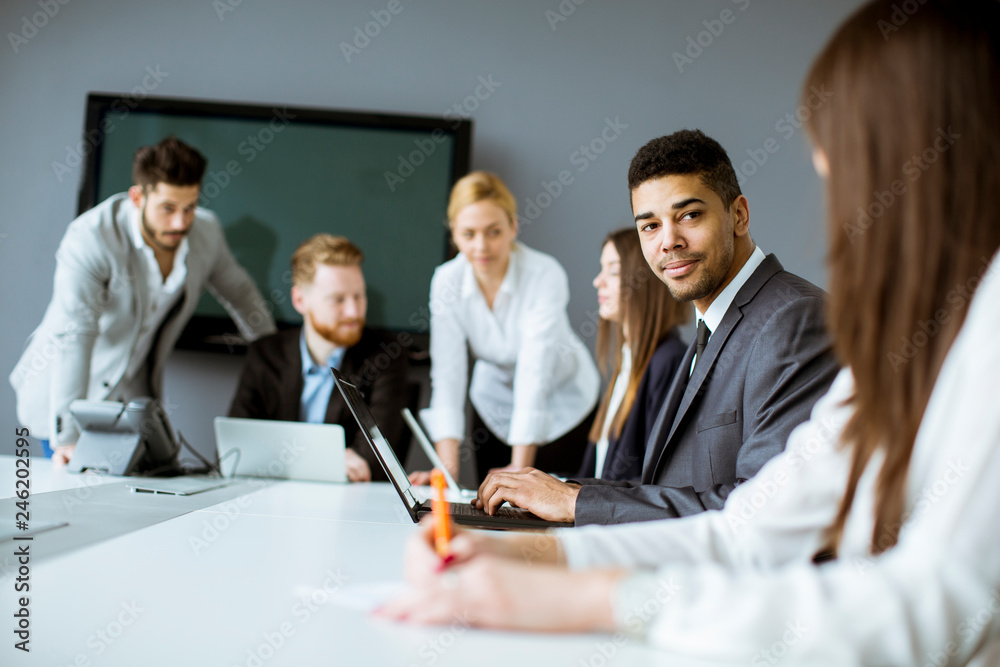 Group of business people sharing their ideas in the office Group of business people sharing their ideas in the office