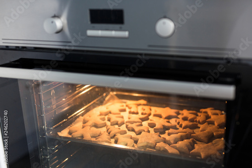 modern oven with cookies or gingerbreads inside