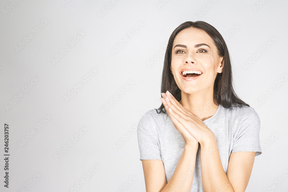 Wow! It's amazing! Portrait of a smiling pretty woman looking up isolated on a white background. Wow! It's amazing! Portrait of a smiling pretty woman looking up isolated on a white background.