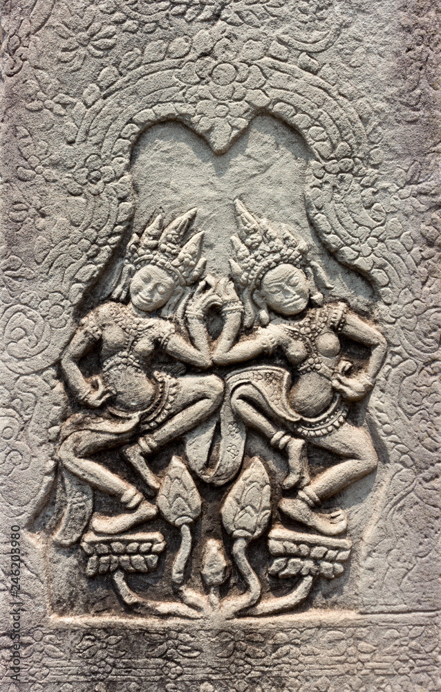 Dancing Apsara of detail religious stone carving decorating on ancient wall Angkor Wat Temple at Siem Reap, Cambodia. Khmer architecture in the modern world. UNESCO World Heritage site