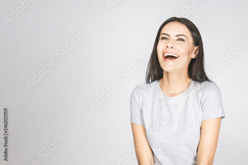 Wow! It's amazing! Portrait of a smiling pretty woman looking up isolated on a white background. © denis_vermenko